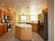 Well-equipped kitchen featuring stainless steel appliances, tile floors, and a kitchen island at 3567 Cottage Stream Ct, Laughlin, NV 89029