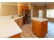 Spacious kitchen with ample counter space, stainless steel refrigerator, and tile flooring at 3567 Cottage Stream Ct, Laughlin, NV 89029