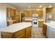 Kitchen featuring white appliances, ample cabinet space, and tiled floors at 3567 Cottage Stream Ct, Laughlin, NV 89029