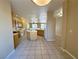 Spacious open-concept kitchen with tile flooring and a central island at 3567 Cottage Stream Ct, Laughlin, NV 89029