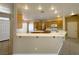 Open kitchen with a breakfast bar, abundant lighting, and tile flooring at 3567 Cottage Stream Ct, Laughlin, NV 89029