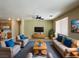 A spacious living room with comfortable seating, modern TV, and an open connection to the kitchen at 3567 Cottage Stream Ct, Laughlin, NV 89029