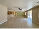 Open-concept living area flows into the kitchen, featuring tiled flooring and sliding glass doors at 3567 Cottage Stream Ct, Laughlin, NV 89029