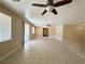 Spacious living room with ceiling fan, tile floors, and sliding glass door access to the exterior at 3567 Cottage Stream Ct, Laughlin, NV 89029