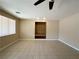 Living room featuring tile flooring, built-in shelving and a large window for natural light at 3567 Cottage Stream Ct, Laughlin, NV 89029