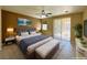Cozy main bedroom featuring a large bed, sliding glass doors, and stylish decor at 3567 Cottage Stream Ct, Laughlin, NV 89029