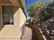 Side yard view with a retaining wall, showing access to backyard at 3567 Cottage Stream Ct, Laughlin, NV 89029