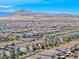 Aerial view showcases 358 Badinerie Street nestled in a vibrant community with mountain views at 358 Badinerie St, Henderson, NV 89011