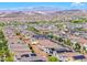 Expansive aerial view of a neighborhood featuring many homes with solar panels with mountains in the background at 358 Badinerie St, Henderson, NV 89011