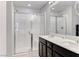 Bathroom featuring double sinks, sleek black cabinetry and glass enclosed shower at 358 Badinerie St, Henderson, NV 89011