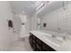 Bright bathroom with a white vanity, shower-tub combo and elegant fixtures at 358 Badinerie St, Henderson, NV 89011