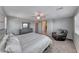 A stylish bedroom featuring a large bed and a grey accent chair at 358 Badinerie St, Henderson, NV 89011