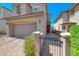 Home exterior features a paved walkway, desert landscaping, gated access, and a two-car garage at 358 Badinerie St, Henderson, NV 89011