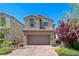Charming two-story home with a paved driveway, desert landscaping, and a tile roof at 358 Badinerie St, Henderson, NV 89011
