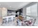Eat-in kitchen featuring dark cabinets, stainless steel appliances, and a stylish island with bar seating at 358 Badinerie St, Henderson, NV 89011