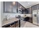 Gourmet kitchen with granite countertops, stainless steel appliances, and dark wood cabinets at 358 Badinerie St, Henderson, NV 89011