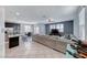 Bright open-concept living room features tile flooring and a large sectional couch at 358 Badinerie St, Henderson, NV 89011