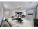Bright open-concept living space with modern furnishings, leading into a dining area and kitchen at 358 Badinerie St, Henderson, NV 89011