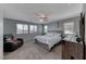 Main bedroom features a large bed and chair, lots of light, and view at 358 Badinerie St, Henderson, NV 89011