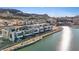 Aerial view of modern waterfront homes lined along a serene lake, offering luxury living and scenic beauty at 36 Lakefront Dr, Henderson, NV 89011