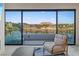 Balcony with comfortable seating and stunning views of the lake and surrounding landscape at 36 Lakefront Dr, Henderson, NV 89011