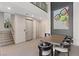 Bright dining room with modern table, chairs, staircase, and whimsical art at 36 Lakefront Dr, Henderson, NV 89011