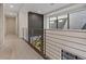 Well-lit hallway with modern railing, large window, and neutral colors creates an open and inviting space at 36 Lakefront Dr, Henderson, NV 89011