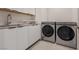 Efficient laundry room featuring modern appliances, ample counter space, and overhead storage for convenience at 36 Lakefront Dr, Henderson, NV 89011