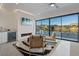 Bright living room with fireplace, wet bar, and expansive windows showcasing beautiful outdoor views at 36 Lakefront Dr, Henderson, NV 89011