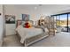 Spacious and bright main bedroom with modern decor, sitting area and outdoor access at 36 Lakefront Dr, Henderson, NV 89011