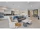 Open-concept living space with a modern kitchen, comfortable seating, and lots of natural light at 36 Lakefront Dr, Henderson, NV 89011