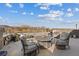 Outdoor patio seating area with a lake view and mountains in the distance at 36 Lakefront Dr, Henderson, NV 89011