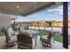 Beautiful outdoor patio with a fire pit and comfortable seating overlooking a serene lake at 36 Lakefront Dr, Henderson, NV 89011