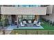 A backyard patio is surrounded by lush greenery and features comfortable seating and a spiral staircase at 36 Lakefront Dr, Henderson, NV 89011
