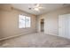 Neutral bedroom with carpet flooring, ceiling fan, window and closet in well-lit home at 3636 Chelsea Gardens Dr, Las Vegas, NV 89135