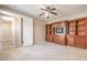 Inviting secondary bedroom with built-in shelves, tile flooring, and neutral carpet, providing ample storage and comfort at 3636 Chelsea Gardens Dr, Las Vegas, NV 89135