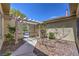 Private courtyard with stone groundcover, pergola, and gated entryway at 3636 Chelsea Gardens Dr, Las Vegas, NV 89135