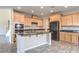 Open-concept kitchen with dark granite countertops and light wood cabinets at 3636 Chelsea Gardens Dr, Las Vegas, NV 89135