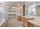 Elegant main bathroom featuring dual vanities, a walk-in closet, a shower, and abundant counter space at 3636 Chelsea Gardens Dr, Las Vegas, NV 89135