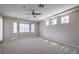 Spacious main bedroom featuring a ceiling fan, bay windows, and access to a private outdoor space at 3636 Chelsea Gardens Dr, Las Vegas, NV 89135