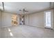 Bright main bedroom showcasing a private entry, ceiling fan, and seamless access to the bathroom and walk-in closet at 3636 Chelsea Gardens Dr, Las Vegas, NV 89135