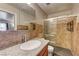 Elegant bathroom features a granite countertop, basin sink, and tiled glass shower at 3924 Blackford Pl, Las Vegas, NV 89102