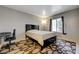 Comfortable bedroom with neutral walls, geometric rug, and a queen-size bed at 3924 Blackford Pl, Las Vegas, NV 89102