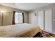 Bedroom showcasing a queen-size bed, window, and closet space for ample storage at 3924 Blackford Pl, Las Vegas, NV 89102
