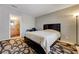 Bedroom view featuring a queen-size bed, bedside table, and an adjacent bathroom at 3924 Blackford Pl, Las Vegas, NV 89102