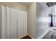 Hallway featuring white folding doors covering a laundry area and tile floors at 3924 Blackford Pl, Las Vegas, NV 89102