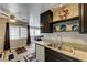 Inviting kitchen featuring granite counters, stainless sink, dark cabinets and an open view to living area with large windows at 3924 Blackford Pl, Las Vegas, NV 89102