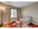 Inviting living room area with a loveseat, standing lamp, and colorful floral rug at 3924 Blackford Pl, Las Vegas, NV 89102