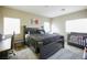 Comfortable bedroom with a modern black bed, desk, and crib near bright windows at 4465 Shimmering Skies St # 2180, North Las Vegas, NV 89031