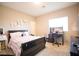 Bedroom features a black framed bed, carpeted floors and a window at 4465 Shimmering Skies St # 2180, North Las Vegas, NV 89031